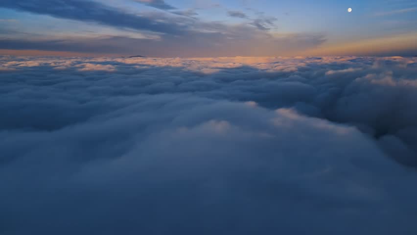 Magic view of foggy landscape at sunrise above blue clouds sky