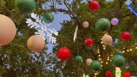 Balls and lighted snowflakes are hung on trees to decorate the garden for Christmas party at dusk. - Powered by Shutterstock - Get 15% off with code: PIKWIZARD15
