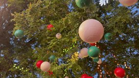 Colorful balls and other Christmas decorations are hung on trees to decorate the garden for Christmas party at dusk. - Powered by Shutterstock - Get 15% off with code: PIKWIZARD15