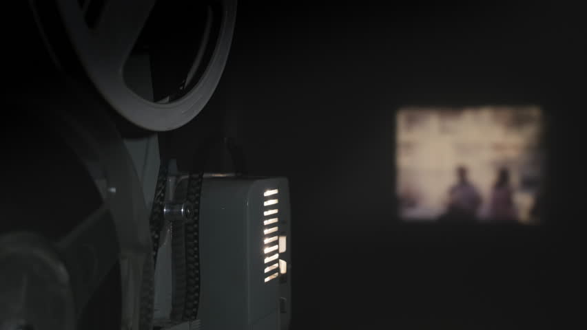 Old 8 mm projector showing film on screen, 4k