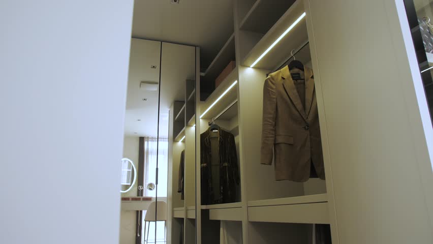 A Stylish Modern Wardrobe designed with Elegant Suits and accented by Chic Lighting