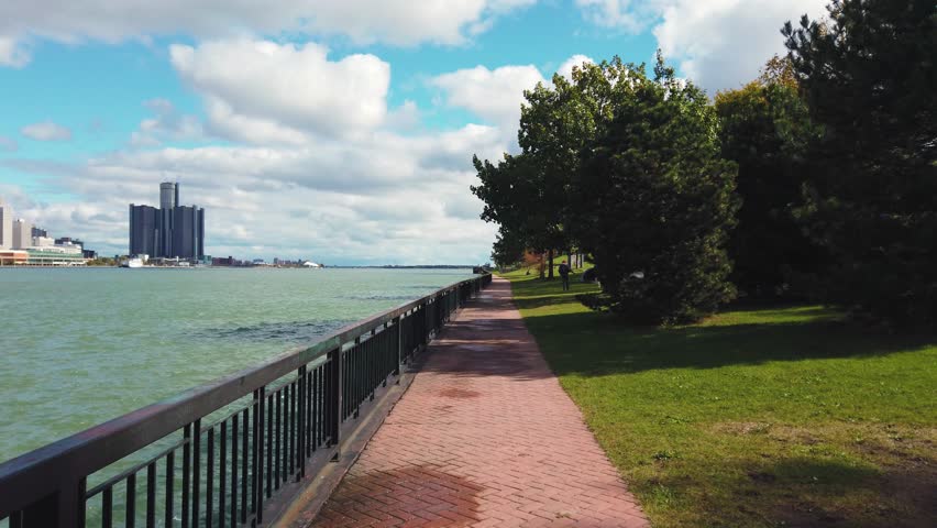 View of the river and the city of Detroit, USA from Canada side. Walking along the Riverfront Trail in Windsor, southwestern Ontario, Canada.