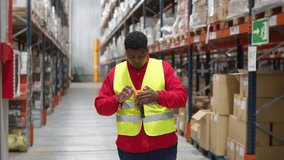 Young male warehouse worker wearing a safety vest is preparing a handheld scanner, captured in slow motion - Powered by Shutterstock - Get 15% off with code: PIKWIZARD15