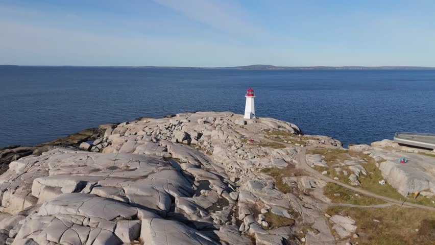 Aerial View A Breathtaking View Of The Historic Lighthouse And Rocky Shore. The Vibrant Sunset Lights Up The Atlantic Ocean, Capturing The Serenity Of Nova Scotia Coastline.