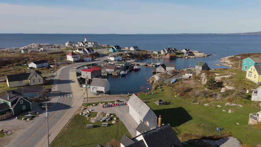 Peggys Cove Lighthouse The Aerial View Highlights Fishing Boats Anchored In The Harbor. The Village And Old Lighthouse Combine To Create A Peaceful Scene Along Nova Scotia Coastline.