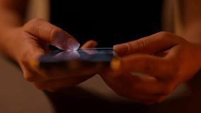 Closeup top view of woman using smartphone in dark room, browsing internet and scrolling screen with finger. Close-up of female hand scrolling using mobile phone social media in dimly lit setting. - Powered by Shutterstock - Get 15% off with code: PIKWIZARD15