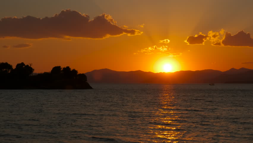 Amazing orange sunset over river waves. An amazing evening over the river with coast during summer time.
