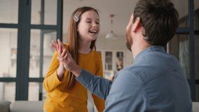 Playful carefree Caucasian family father man daddy male giving high five child girl clap touching parent dad daughter holding hands little kid schoolgirl smiling laugh good job gesture success at home - Powered by Shutterstock - Get 15% off with code: PIKWIZARD15