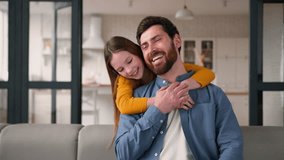 Playful little Caucasian daughter child surprise dad man cheerful naughty girl kid distracting embrace parent guy daddy male father working typing laptop device smile at home family hugging touching - Powered by Shutterstock - Get 15% off with code: PIKWIZARD15