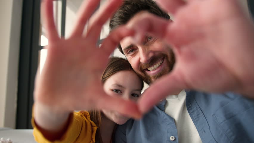 Happy Caucasian family smiling daughter little child carefree dad man guy showing heart love gesture with hands together adorable symbol at home kid girl male father looking at camera trust parenting - Powered by Shutterstock - Get 15% off with code: PIKWIZARD15
