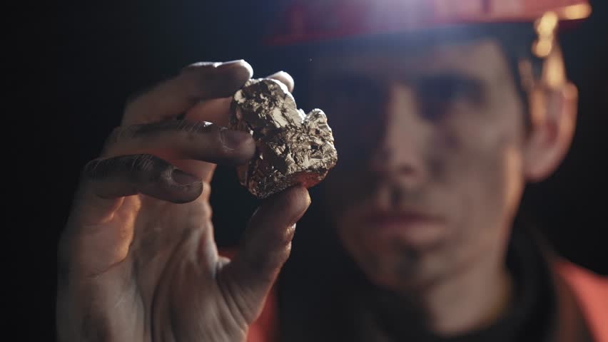 Gold Prospector Examining a Nugget Found During His Hunt