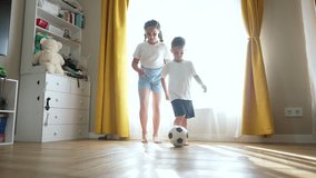Children playing soccer with indoors. Joyful kids having fun with soccer ball at home. Siblings bond over ball. Soccer ball game brings happiness. Children play soccer ball in cozy home environment. - Powered by Shutterstock - Get 15% off with code: PIKWIZARD15