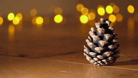 Pine cone in front of Christmas lights bokeh close up zoom shot selective focus - Powered by Shutterstock - Get 15% off with code: PIKWIZARD15