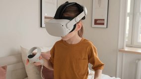 Two young sisters share a fun moment in their bedroom. One excitedly uses a VR headset and controllers, while the other watches, creating a scene of playful sibling interaction and modern technology.  - Powered by Shutterstock - Get 15% off with code: PIKWIZARD15