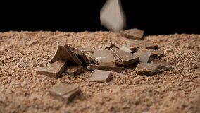 Chunks of milk chocolate falling into chocolate chips slow motion - Powered by Shutterstock - Get 15% off with code: PIKWIZARD15