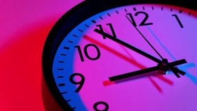 Clock face with blue and red colors. Time ticking on classic wall clock. Timelapse. Clock face on colorful background. Time concept. Wall clock show running time. Close-up in 4K, UHD - Powered by Shutterstock - Get 15% off with code: PIKWIZARD15