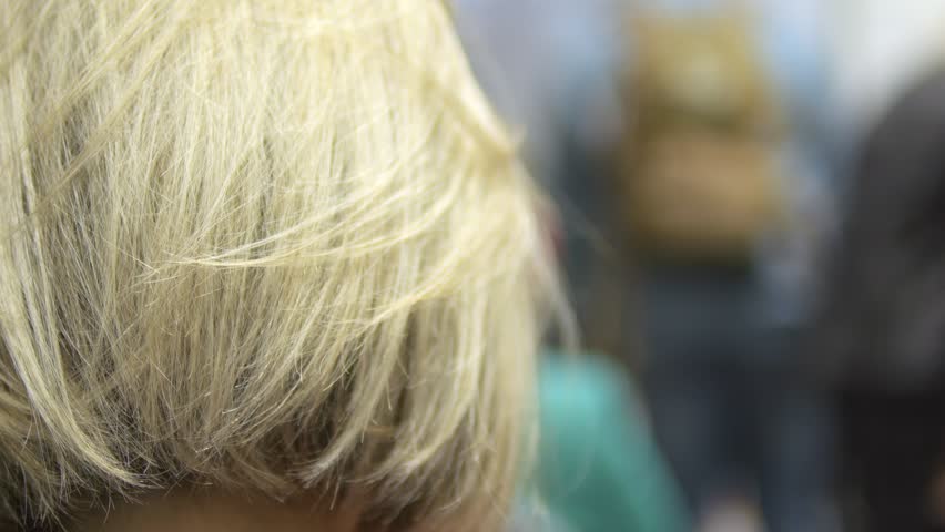 A CloseUp Representation of Blonde Hair Captured Within a Busy Crowd Setting Around