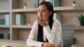 Professional Asian Chinese business woman female girl Japanese entrepreneur businesswoman worker use mobile phone app record voice audio message speakerphone talk smartphone online call inside office - Powered by Shutterstock - Get 15% off with code: PIKWIZARD15