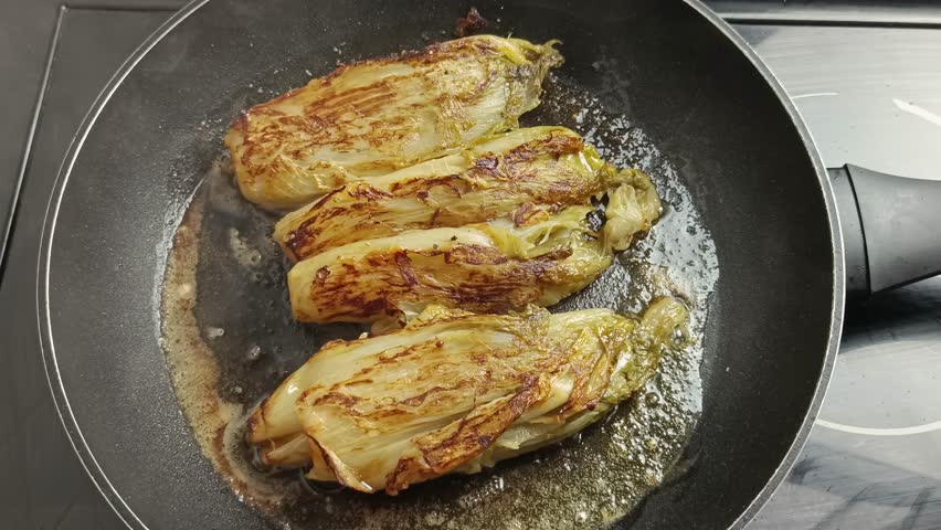 braised endives, cooked in a pan