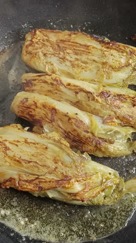 braised endives, cooked in a pan