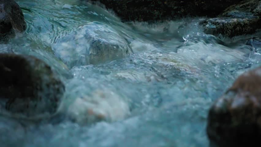 Slow motion close up of water flowing at Hedionda de Casares Roman bath, Spain