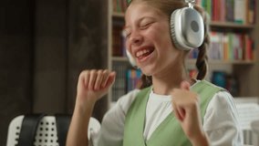 Caucasian teen girl student schoolgirl daughter pupil listening music audio song in headphones happy child kid listen sound earphones studying class lesson learning break fun smiling dancing in school - Powered by Shutterstock - Get 15% off with code: PIKWIZARD15