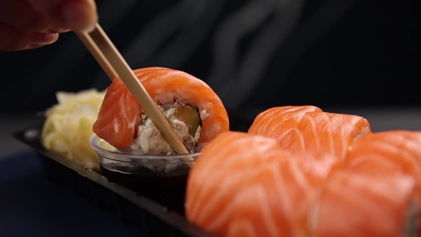 the chef cooks delicious salmon rolls. Japanese cuisine