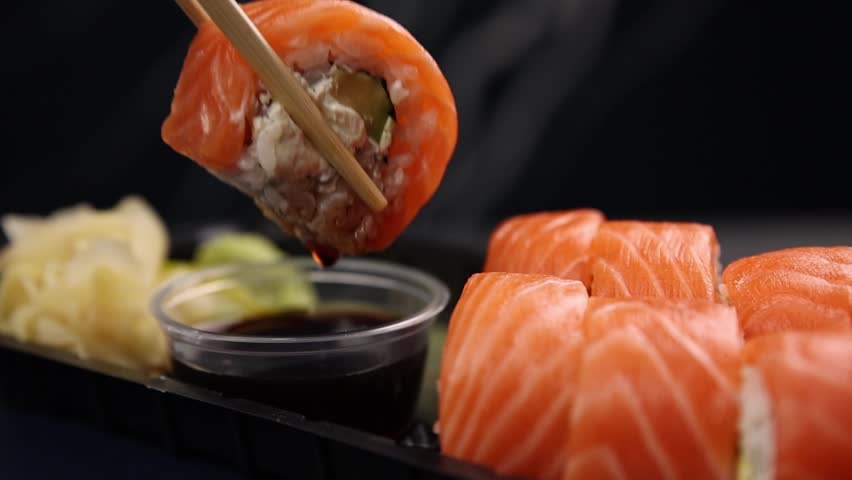the chef cooks delicious salmon rolls. Japanese cuisine
