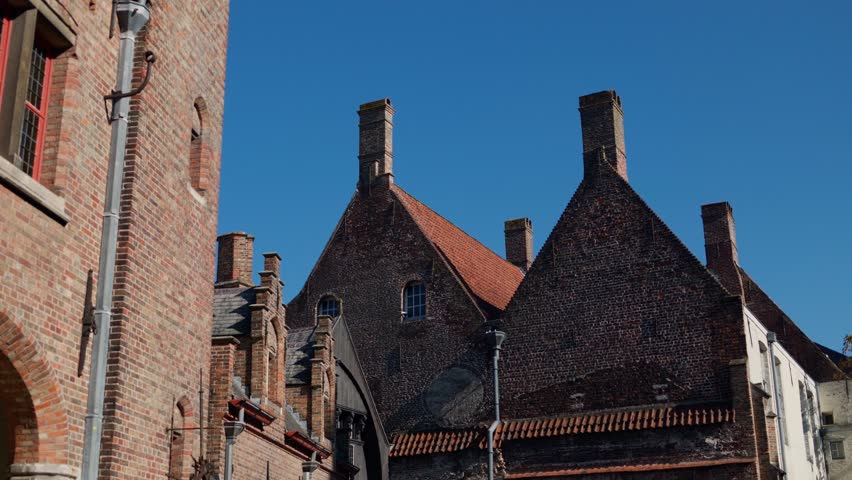 Historic Bruges architecture captured under a bright blue sky, timeless beauty