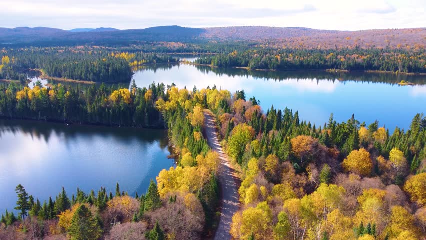 Calm Lake Surrounding Mont Tremblant in Quebec, Wide Aerial Drone Shot