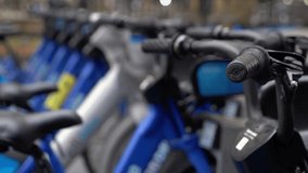 Blue city bikes are neatly lined up, beautifully showcasing bike sharing options that are perfect for urban commuters. Citibike - Powered by Shutterstock - Get 15% off with code: PIKWIZARD15