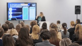 People in a conference room attentively listening to a technology presentation on a screen. - Powered by Shutterstock - Get 15% off with code: PIKWIZARD15