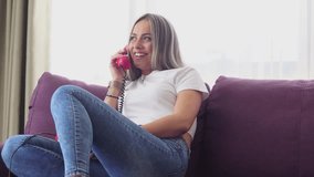 Young Woman Talking Over Old Rotary Landline Telephone While Sitting on Couch in Her Home - Powered by Shutterstock - Get 15% off with code: PIKWIZARD15