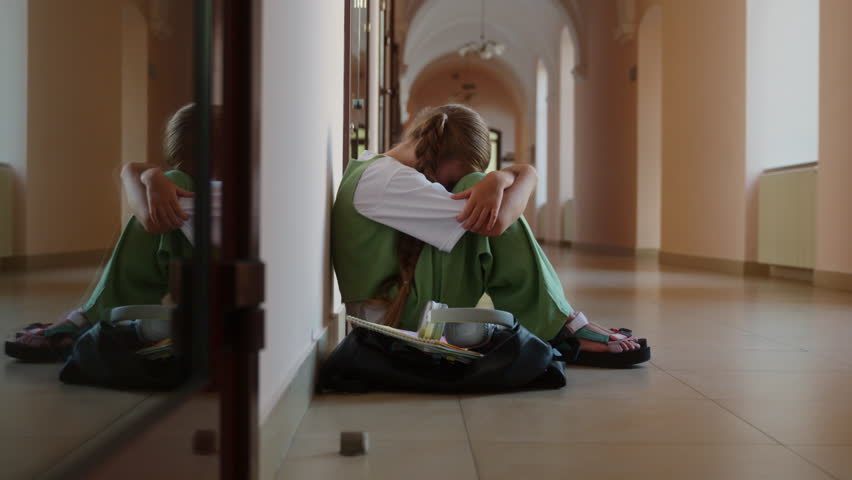 Caucasian sad alone worried stressed girl student schoolgirl daughter child kid teenager pupil suffer sit floor in corridor upset bullying abuse in school university college studying problem education