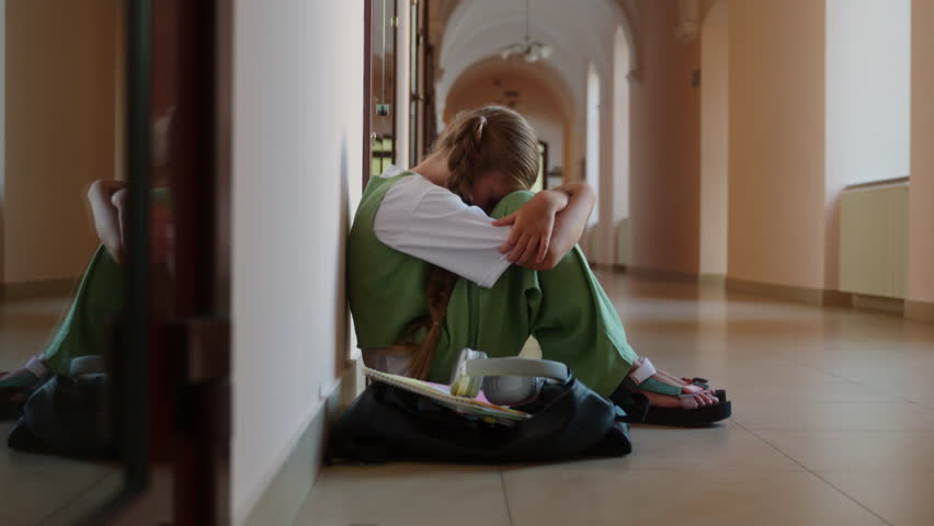 Caucasian sad alone worried stressed girl student schoolgirl daughter child kid teenager pupil suffer sit floor in corridor upset bullying abuse in school university college studying problem education