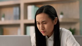 Confused grumpy Asian Japanese businesswoman female girl Chinese Korean business woman worker online work laptop pc computer problem shock bad failure mistake negative shaking head no in office room - Powered by Shutterstock - Get 15% off with code: PIKWIZARD15