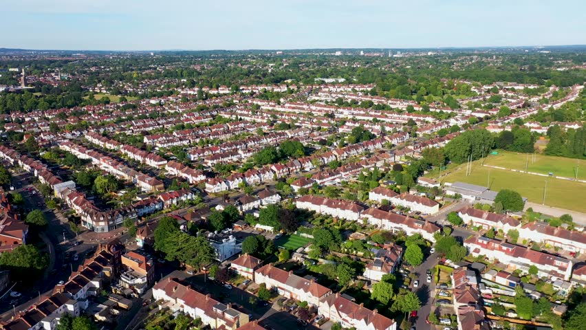 Aerial drone footage of the town of Beckenham which is in Greater London in the UK showing British houses and row of homes in the housing estates from above on a sunny day in the summer time