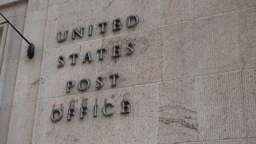 The impressive facade of a United States Post Office beautifully showcases its classic and iconic lettering design