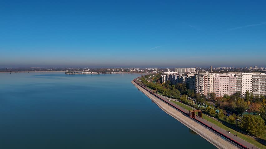 Drone Shot of Lacul Morii and Crangasi Neighborhood, with Apartment Blocks in the Distance, Sector 6, Bucharest, Romania