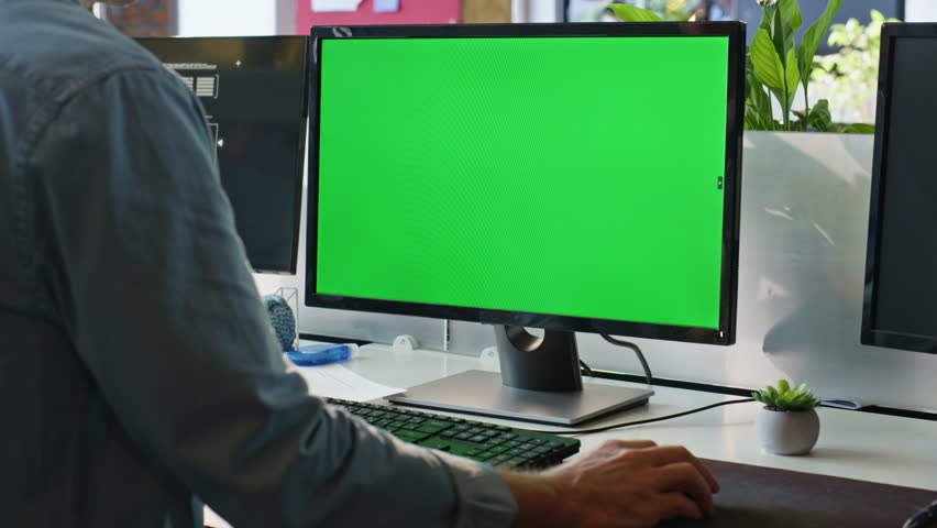 Office guy using chromakey computer closeup. Worker hand holding mouse device working green screen pc at cozy workplace. Unrecognizable director looking mockup monitor. Unknown manager searching data 