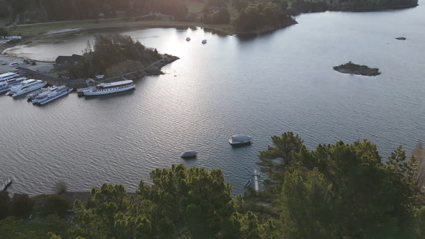 Aerial orbit of Puerto Pañuelo with boats docked on Lake Nahuel Huapi near San Carlos de Bariloche