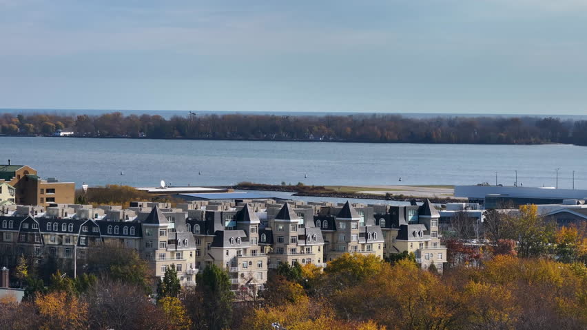 Drone shot from a distance tracking a small plane landing at the island airport in downtown Toronto