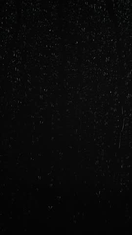 Vertical water rainfall, rain drops falling on window glass on black background