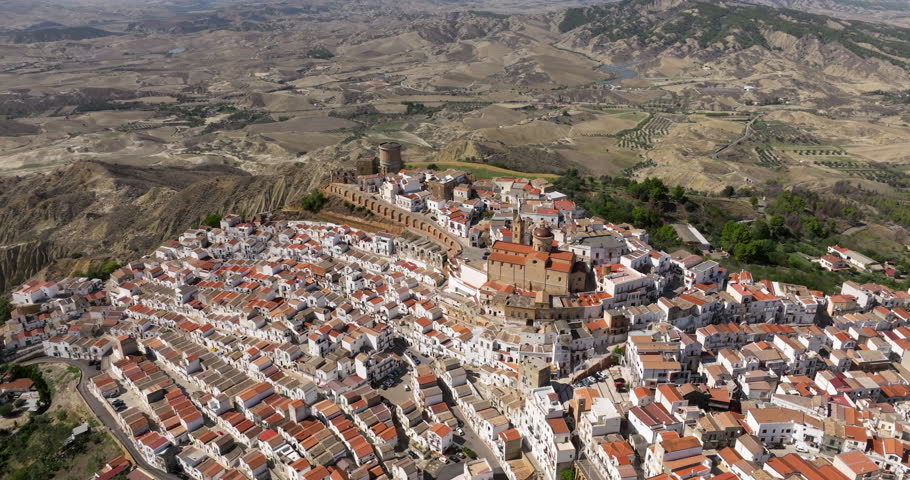 Dense City Nestled Over Hill At Pisticci In Matera Province, Basilicata, Southern Italy. Aerial Drone Shot