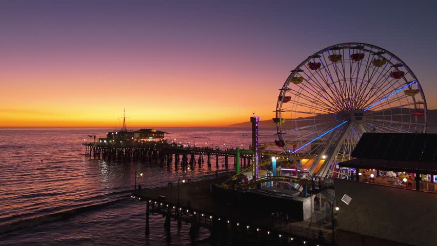 Sunset over a pier SANTA MONICA, LOS ANGELES