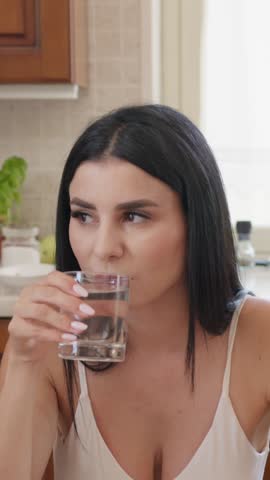Calabrian Woman Drinks From Transparent Glass Of Water At Home