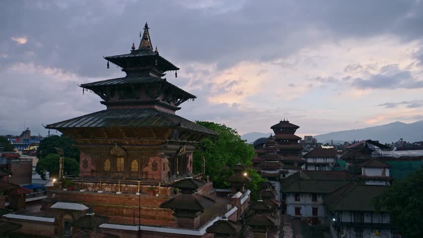 Kathmandu Temple at Night in Nepal Under Beautiful Dramatic Sunset Sky with Amazing Sunset Purple Clouds, Durbar Square Temples and Old Historic Buildings in City Centre