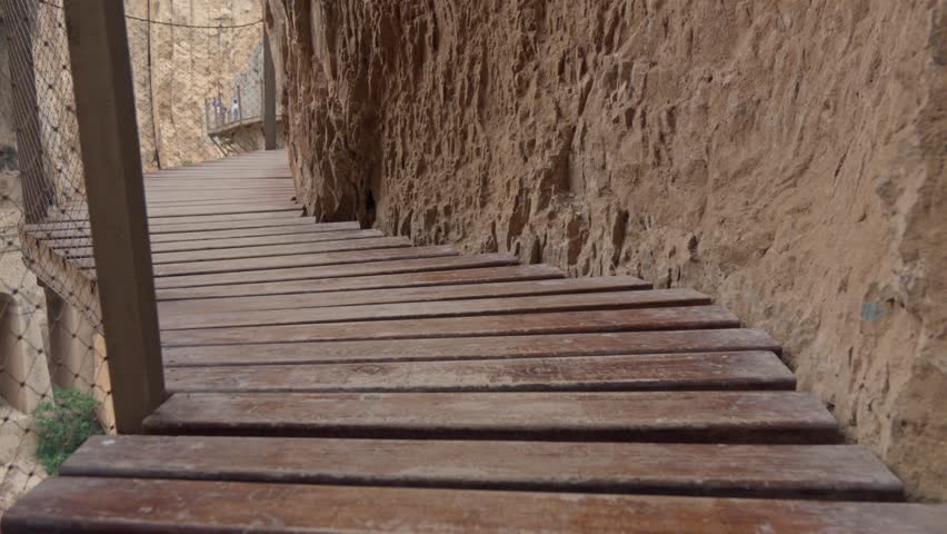 Scenic wooden walkway along rocky cliffside path