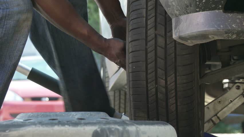 Detail view of wheel being replaced on a car.