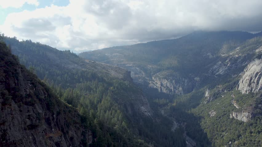 An aerial footage of the Merced River Valley in Yosemite National Park on a sunny day in California's Sierra Nevada mountains, USA